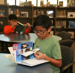 student reading book in library